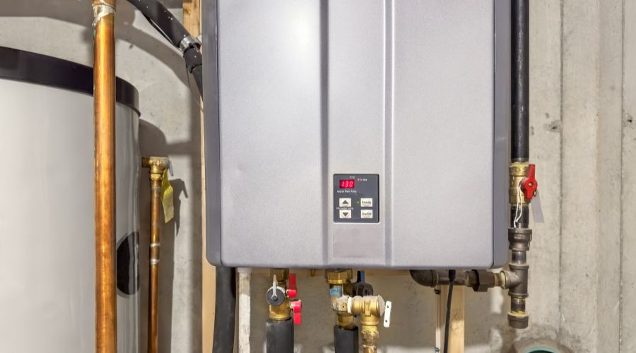 Tankless water heater installation with digital display and plumbing connections, highlighting energy-efficient hot water solution for homes.